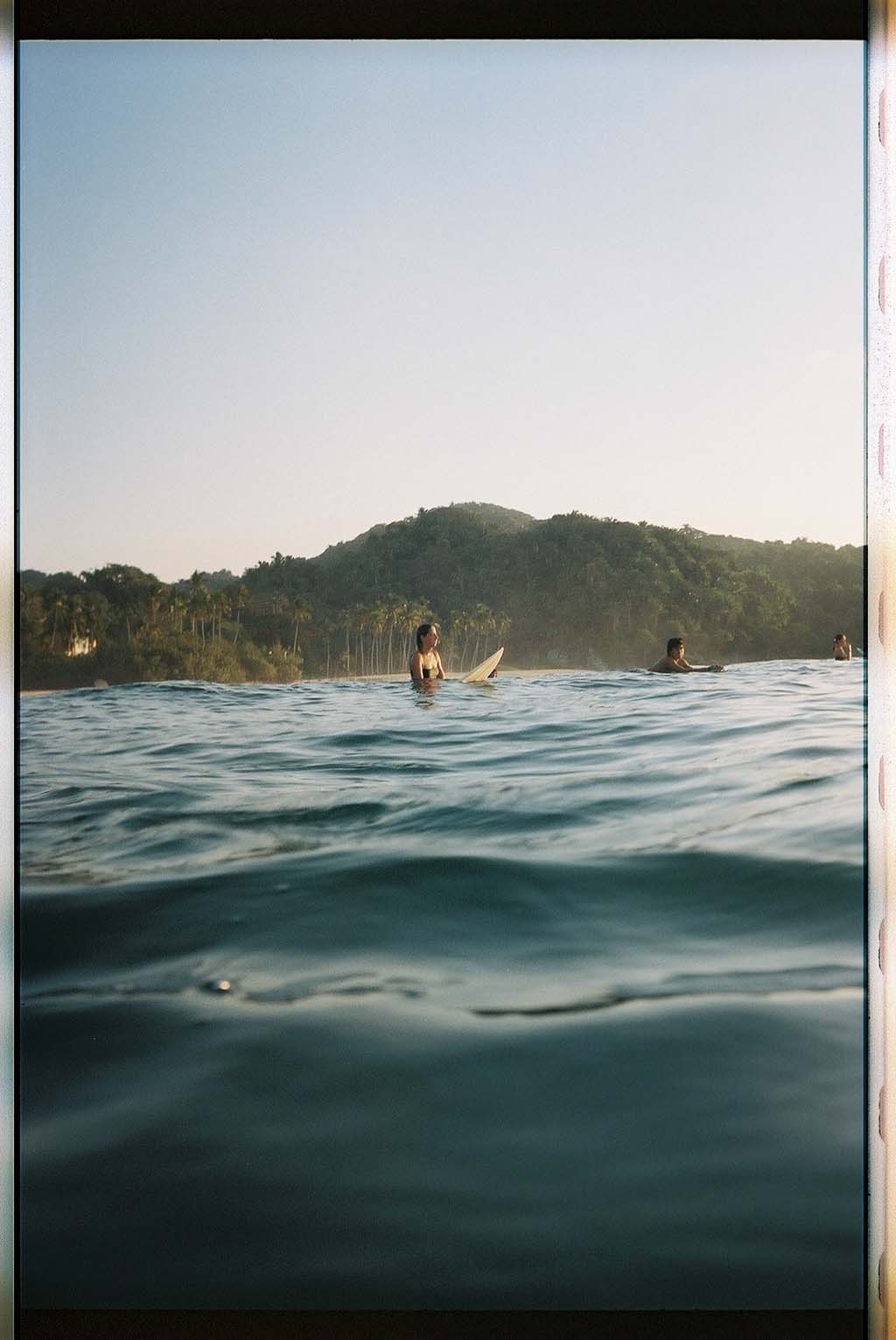 Surfer sitting in the water on board