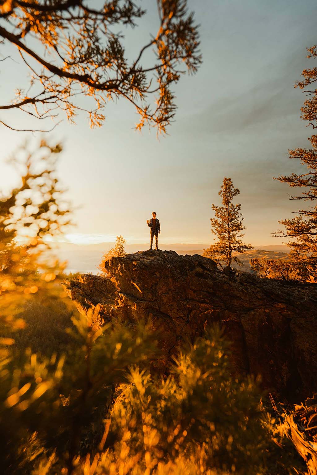 Man Holding a Beer in the Mountains by Jordan McGarth